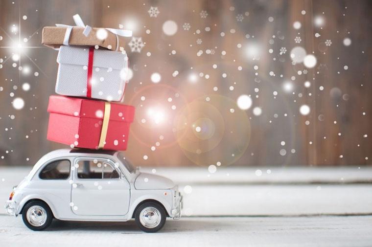 Gift boxes stacked on top of a toy car