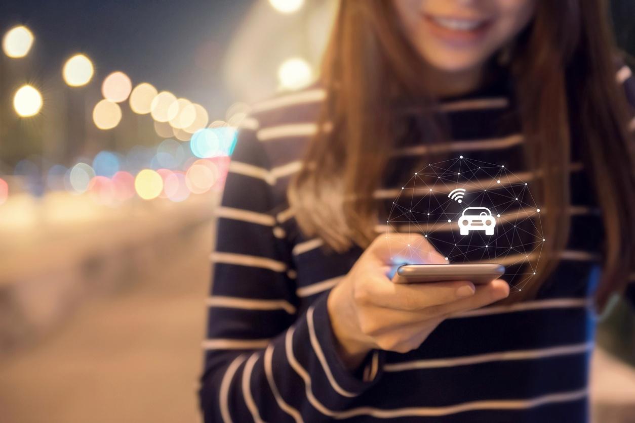 Woman using phone to access car club vehicle 