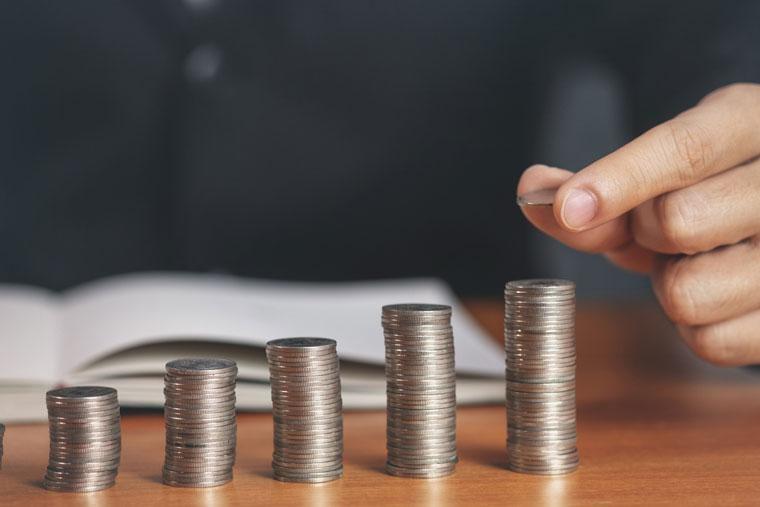 Man stacking money coins