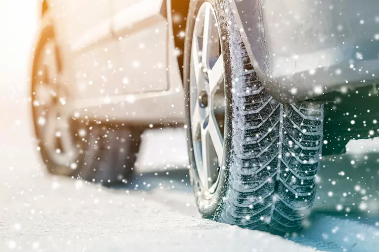 Car wheels in deep winter snow