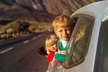 Children enjoying a car journey