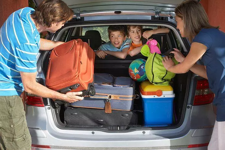 family preparing car for holiday 