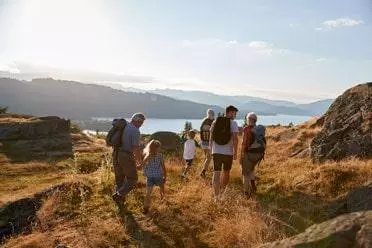 Family walking on hill in Lake District UK