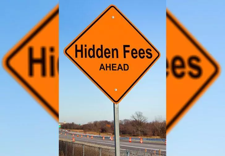 Hidden fees ahead road sign