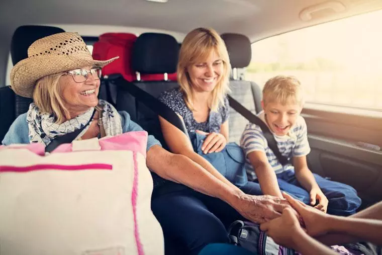 Senior woman with family on road trip