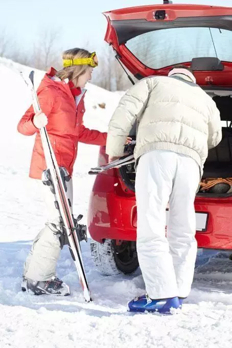 Skiers with rental car
