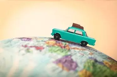 Vacationing toy car on a globe