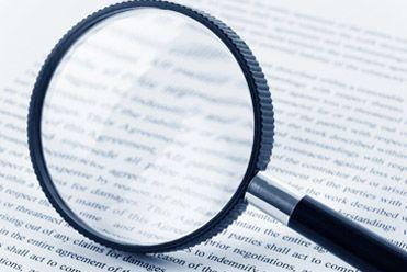 magnifying glass and paperwork