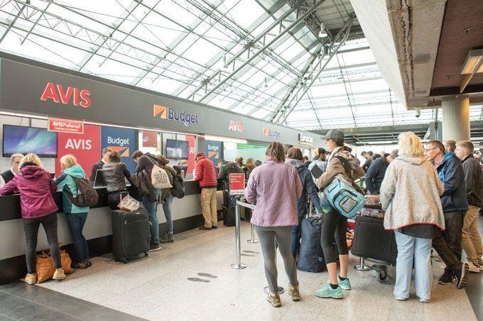 Travellers waiting at the rental desk